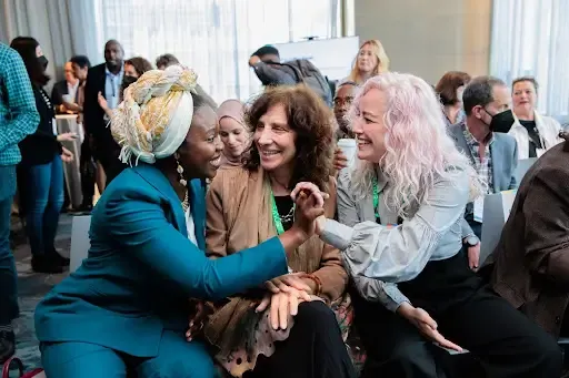 Three women holding hands